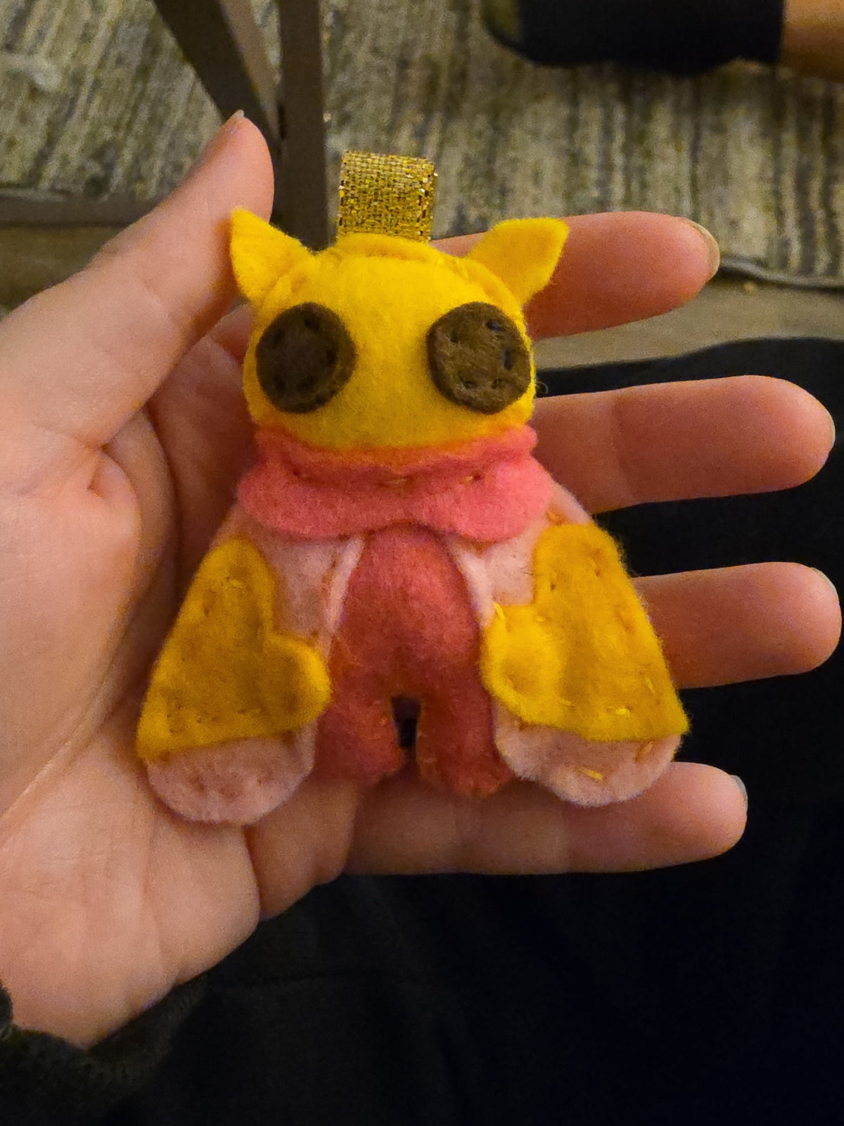 Handmade felt Rosy Maple Moth keychain front view with silver keychain hardware